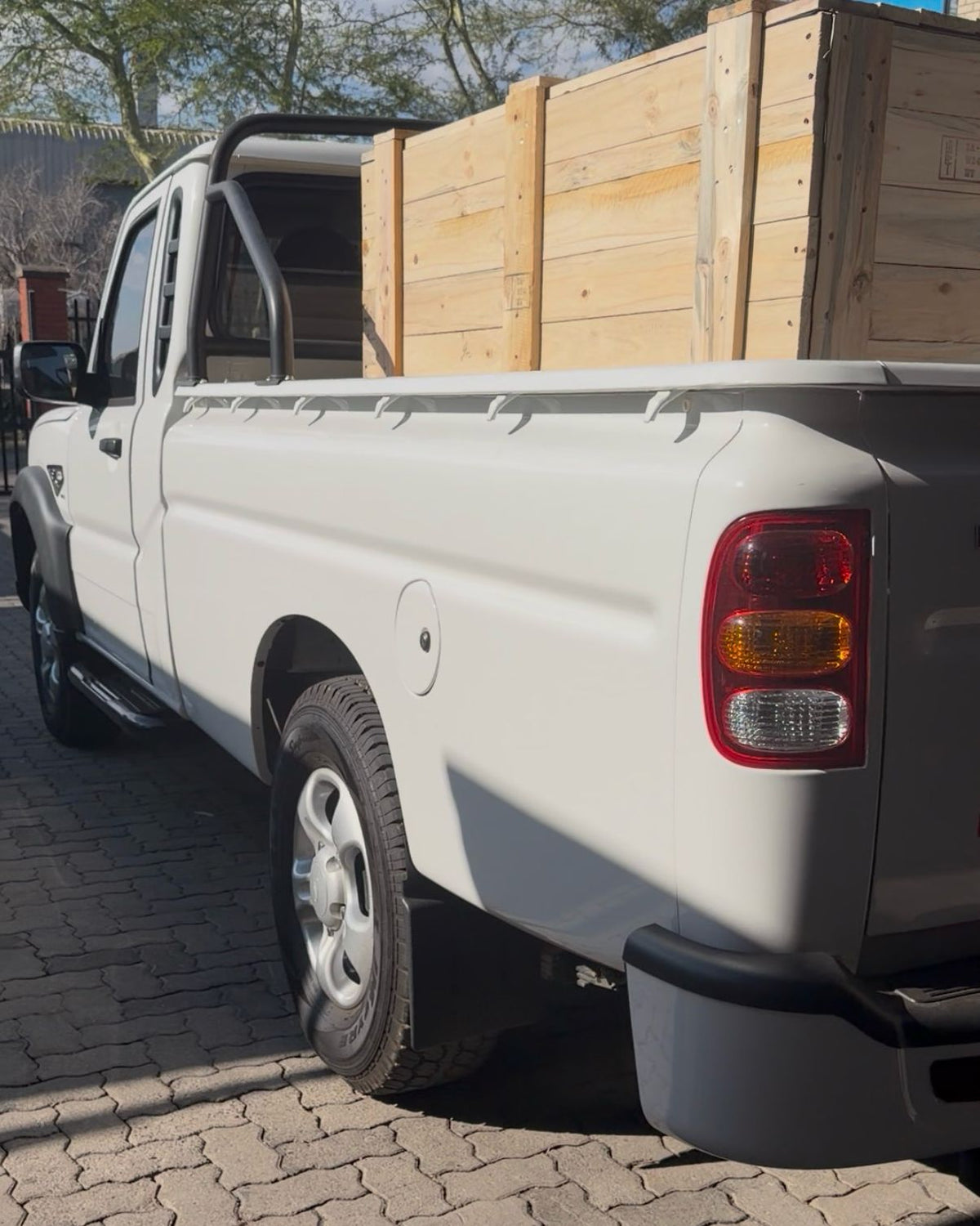 Timber crates loaded in the back of the white Mahindra S4 bakkie