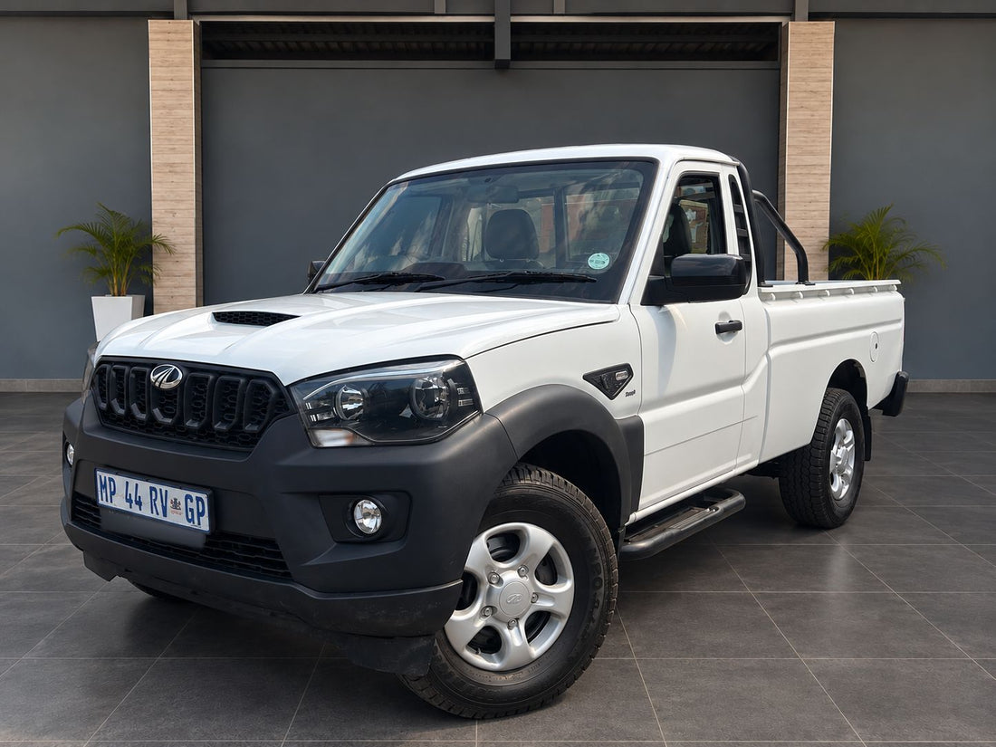 White Mahindra S4 single-cab bakkie with a roll bar, front three-quarter view